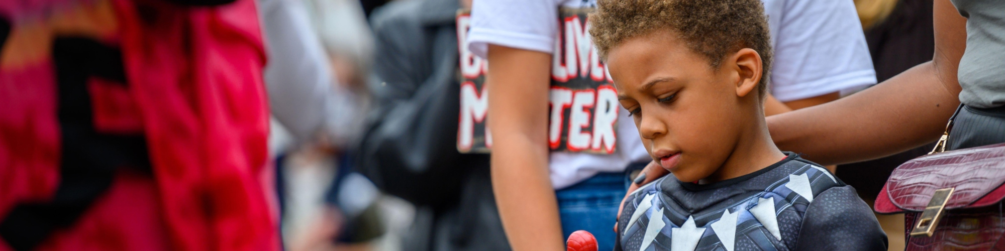 boy of color dressed as a super hero 