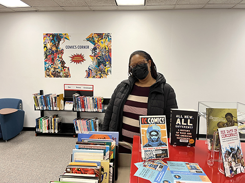 Qiana Whitted with comics display